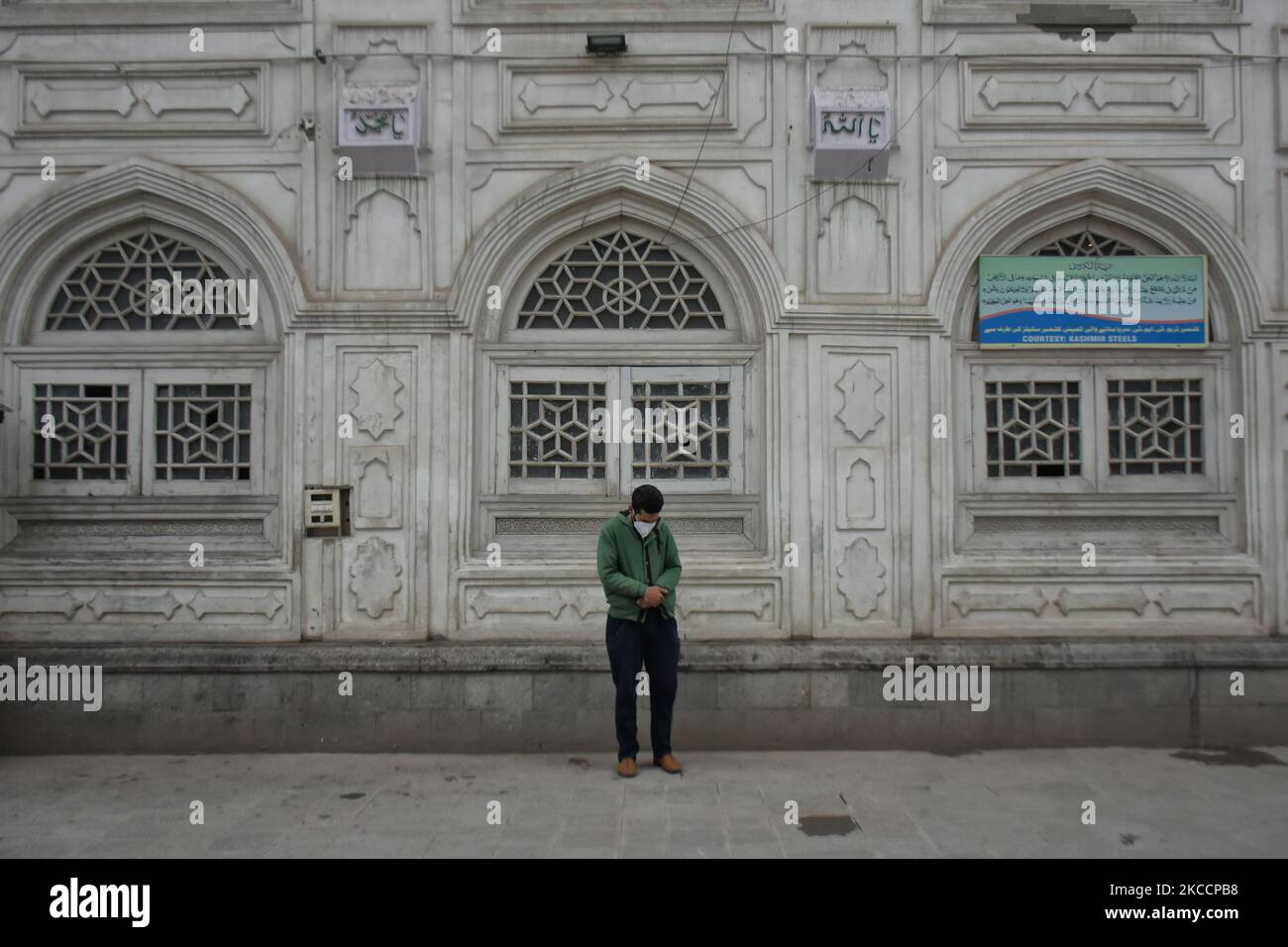 A Kashmiri man prays outside a shrine on the first day of Ramadan ...