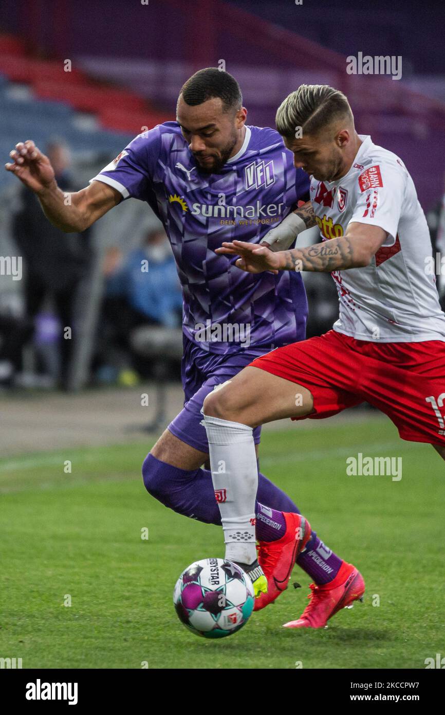Jay-Roy Grot (left) of VfL Osnabrueck and Erik Wekesser (right) of SSV Jahn Regensburg battle for the ball during the Second Bundesliga match between VfL Osnabrueck and SSV Jahn Regensburg at Bremer Bruecker on April 14, 2021 in Osnabrueck, Germany. (Photo by Peter Niedung/NurPhoto) Stock Photo