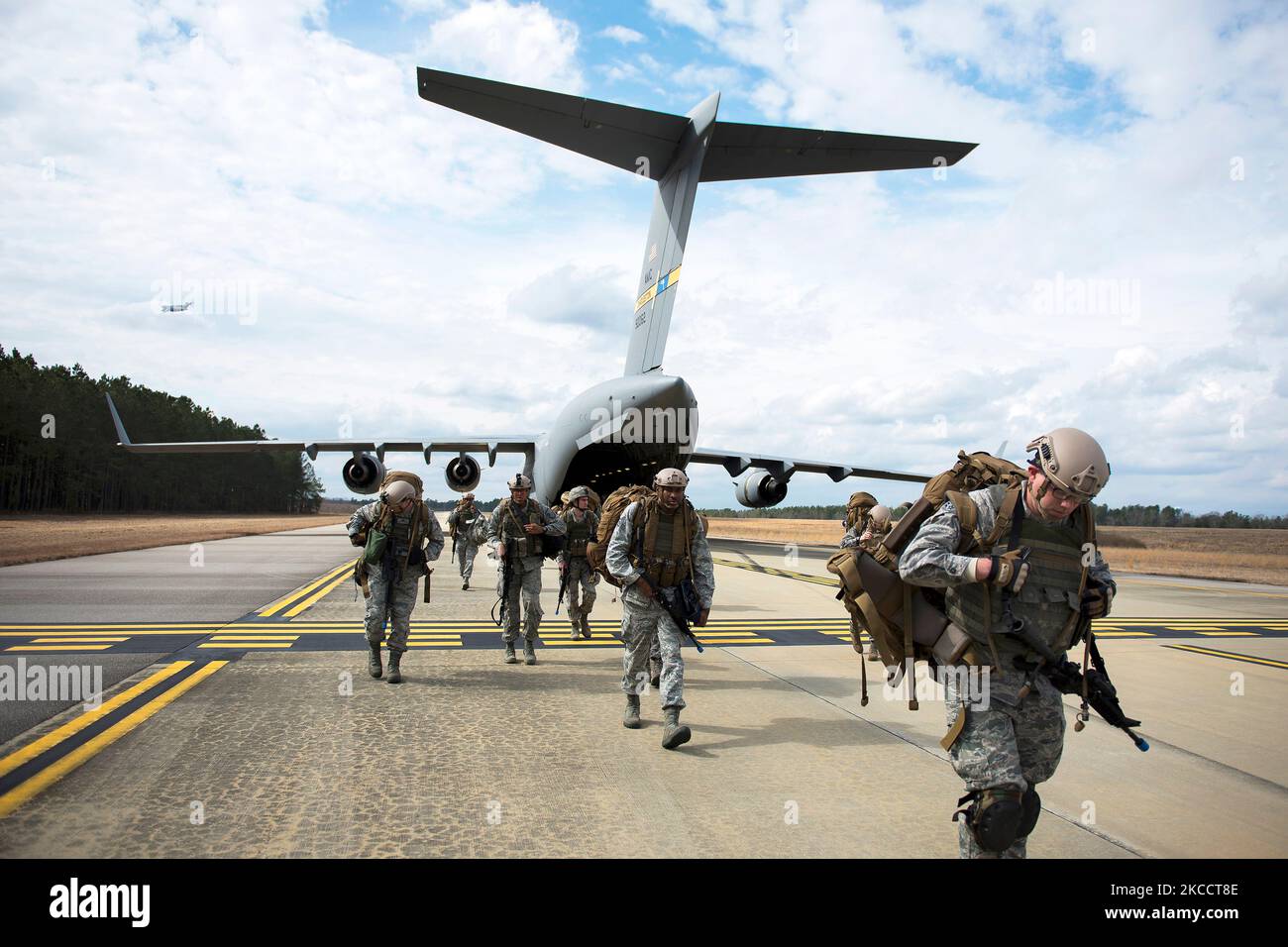 Airmen exit a C-17 Globemaster III. Stock Photo