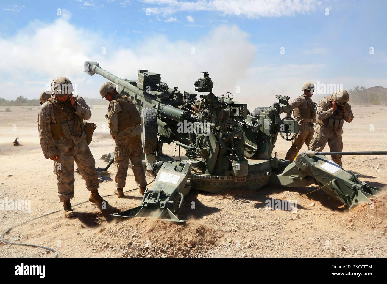 U.S. Marine Corps artillerymen fire an M777 Howitzer weapons system. Stock Photo