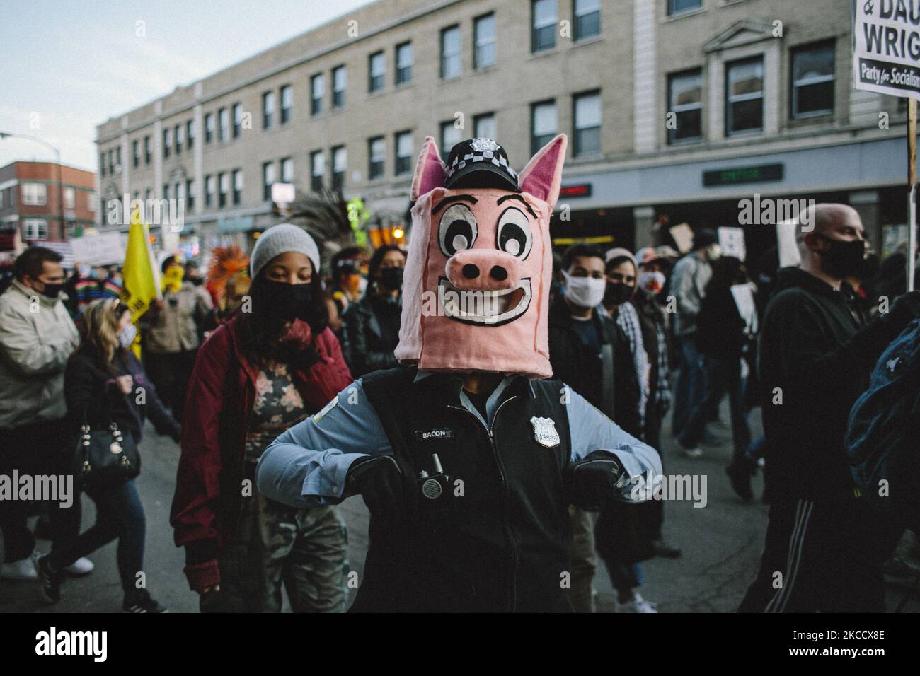 A protester dressed like a pig in a Chicago Police Officer's uniform, marches down the street in Chicago on April 16, 2021. Thousands of protesters came out to call for police accountability after an officer shot and killed 13 year old Adam Toledo in the Little Village neighbourhood on Chicago's south side. (Photo by Jim Vondruska/NurPhoto) Stock Photo