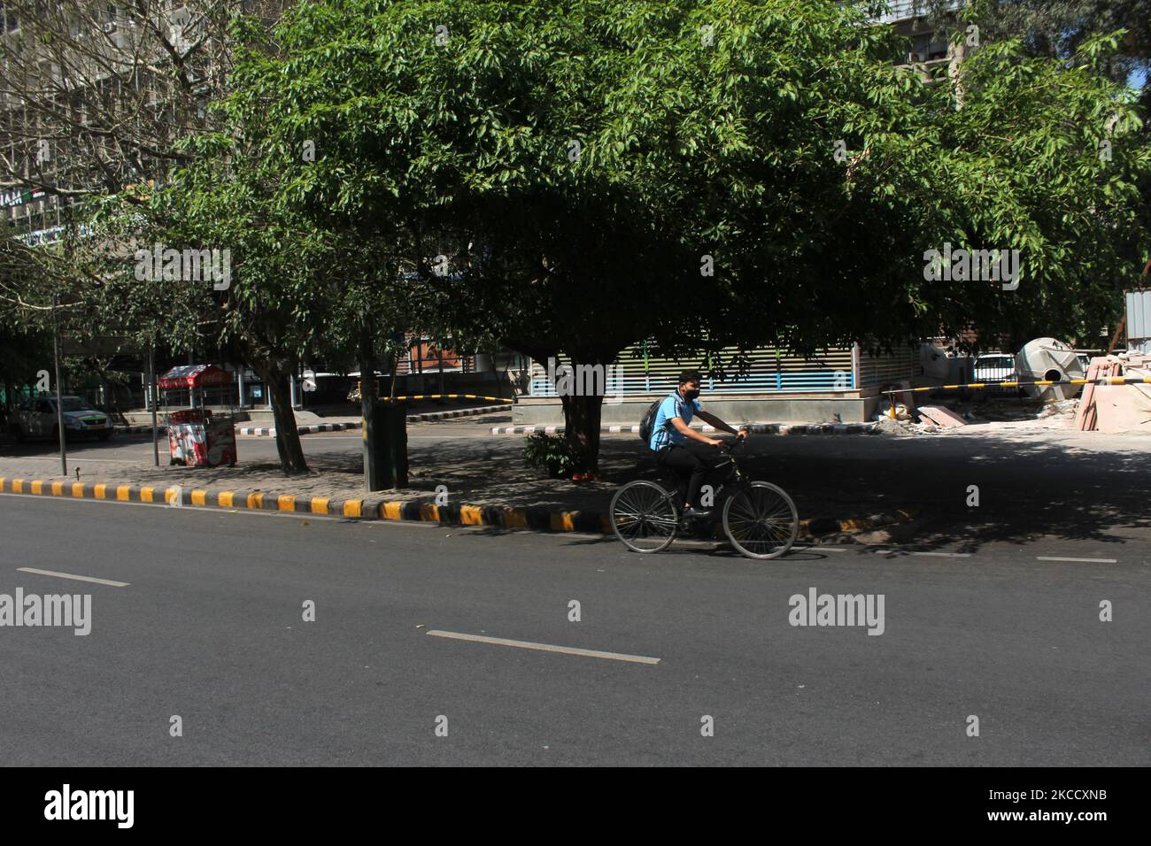 A cyclist pedals past a deserted street during a weekend lockdown in New Delhi, India on April 17, 2021. India on Saturday reported 2,34,692 new Covid-19 cases and 1,341 deaths in the last 24 hours, according to data from the Union Health Ministry. (Photo by Mayank Makhija/NurPhoto) Stock Photo