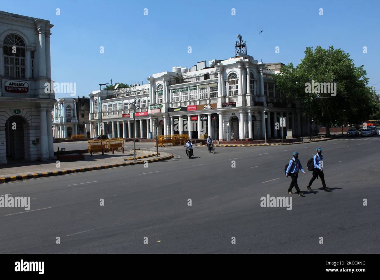 Men walk past a deserted street during a weekend lockdown at Connaught Place in New Delhi, India on April 17, 2021. India on Saturday reported 2,34,692 new Covid-19 cases and 1,341 deaths in the last 24 hours, according to data from the Union Health Ministry. (Photo by Mayank Makhija/NurPhoto) Stock Photo
