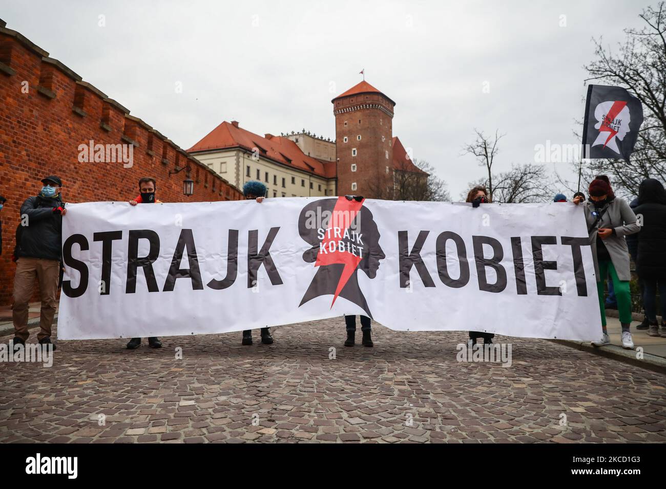 People hold Women Strike banner while demonstrate against Polish far-right government. Krakow, Poland on April 18th, 2021. Protestors came to welcome the members of PiS (Law and Justice) rulling party who arrived to Wawel Castle to celebrate the 11th anniversary of the funeral of the presidential couple Lech and Maria Kaczynski, who died on 10 April 2010, after a Polish Air Force Tu-154 crashed outside of Smolensk, Russia. (Photo by Beata Zawrzel/NurPhoto) Stock Photo