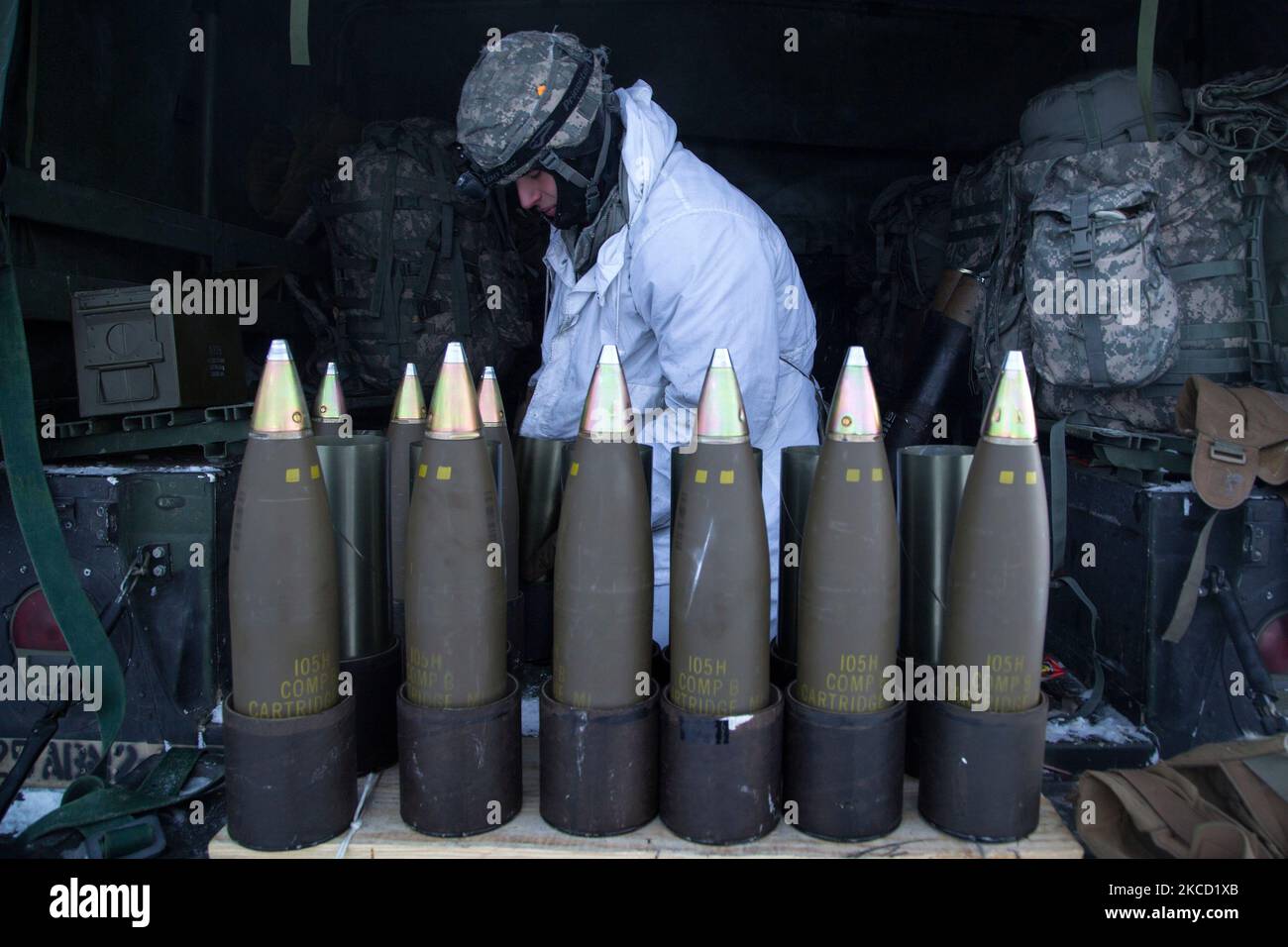 A paratrooper prepares 105mm high explosive rounds. Stock Photo