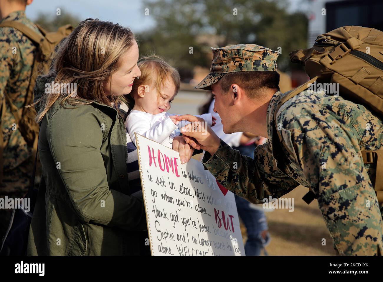 A U.S. Marine is welcomed home by his family. Stock Photo