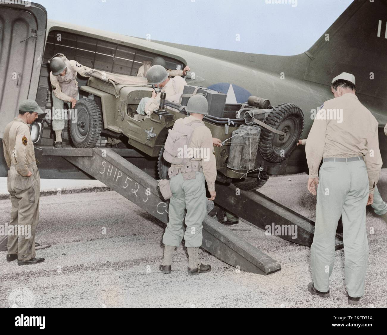 A jeep is being loaded into a plane, circa 1942. Stock Photo
