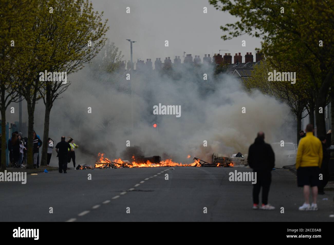 Loyalists burn bins and furniture during a protest on Lanark Way, near