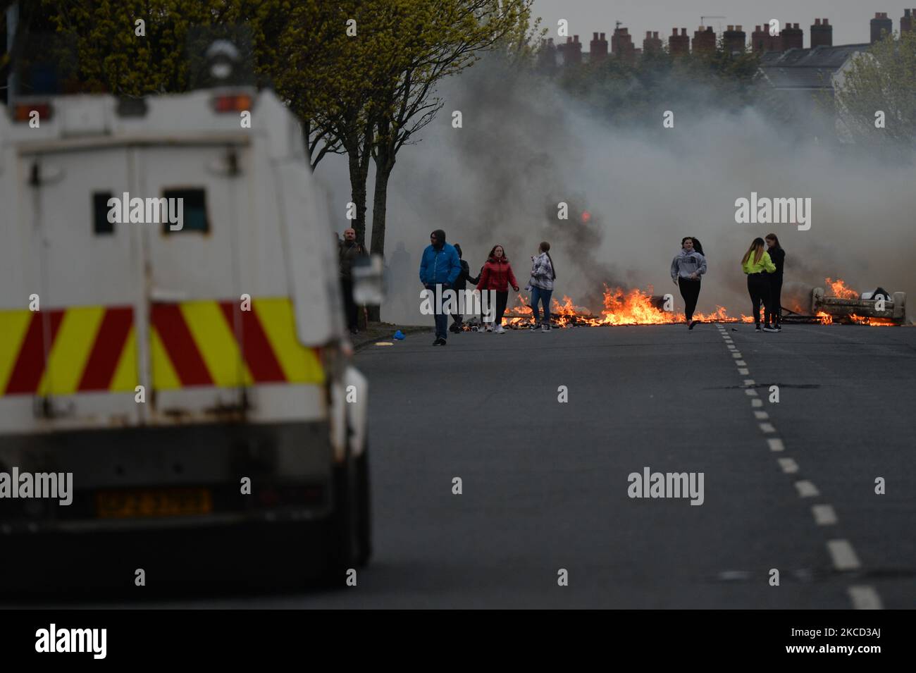 Loyalists burn bins during a protest on Lanark Way, near the 'Peace