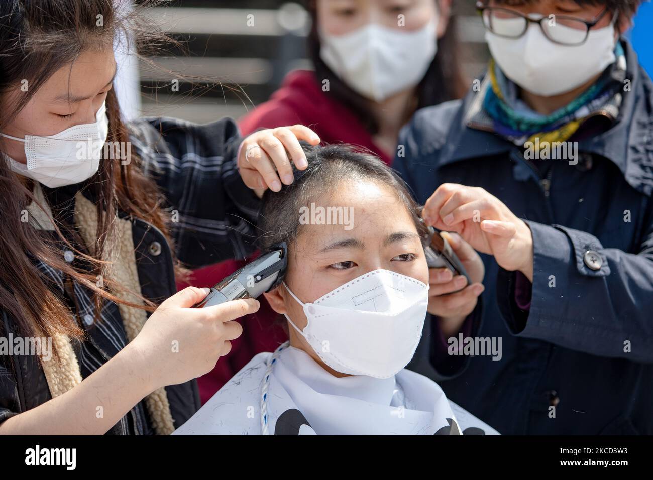 A South Korean college student protester shaves her hairs in a protest against Japan's decision to release radioactive water from the Fukushima Nuclear Power Plant into the ocean, at in front of the Japanese embassy on 20 April, 2021 in Seoul, South Korea. On April 13th, the Japanese government decided to discharge radioactive water from the crippled Fukushima nuclear plant into the Pacific Ocean. (Photo by Chris Jung/NurPhoto) Stock Photo