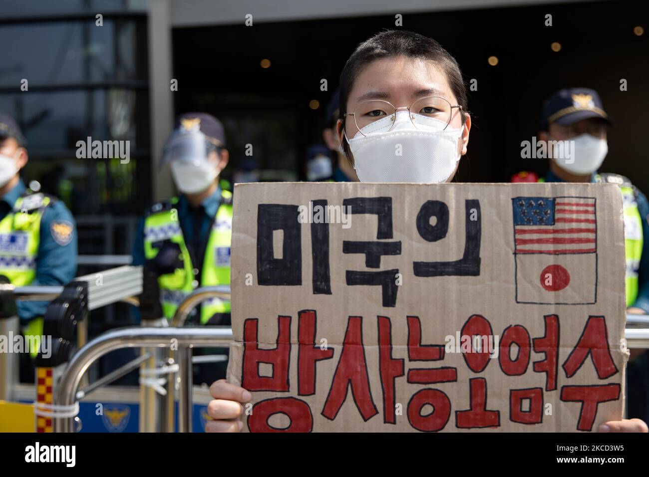 A protester holds a banner written in Don't release radioactive contaminated water! during a protest against Japan's decision to release radioactive water from the Fukushima Nuclear Power Plant into the ocean, in front of the Japanese embassy on 20 April, 2021 in Seoul, South Korea. On April 13th, the Japanese government decided to discharge radioactive water from the crippled Fukushima nuclear plant into the Pacific Ocean. (Photo by Chris Jung/NurPhoto) Stock Photo