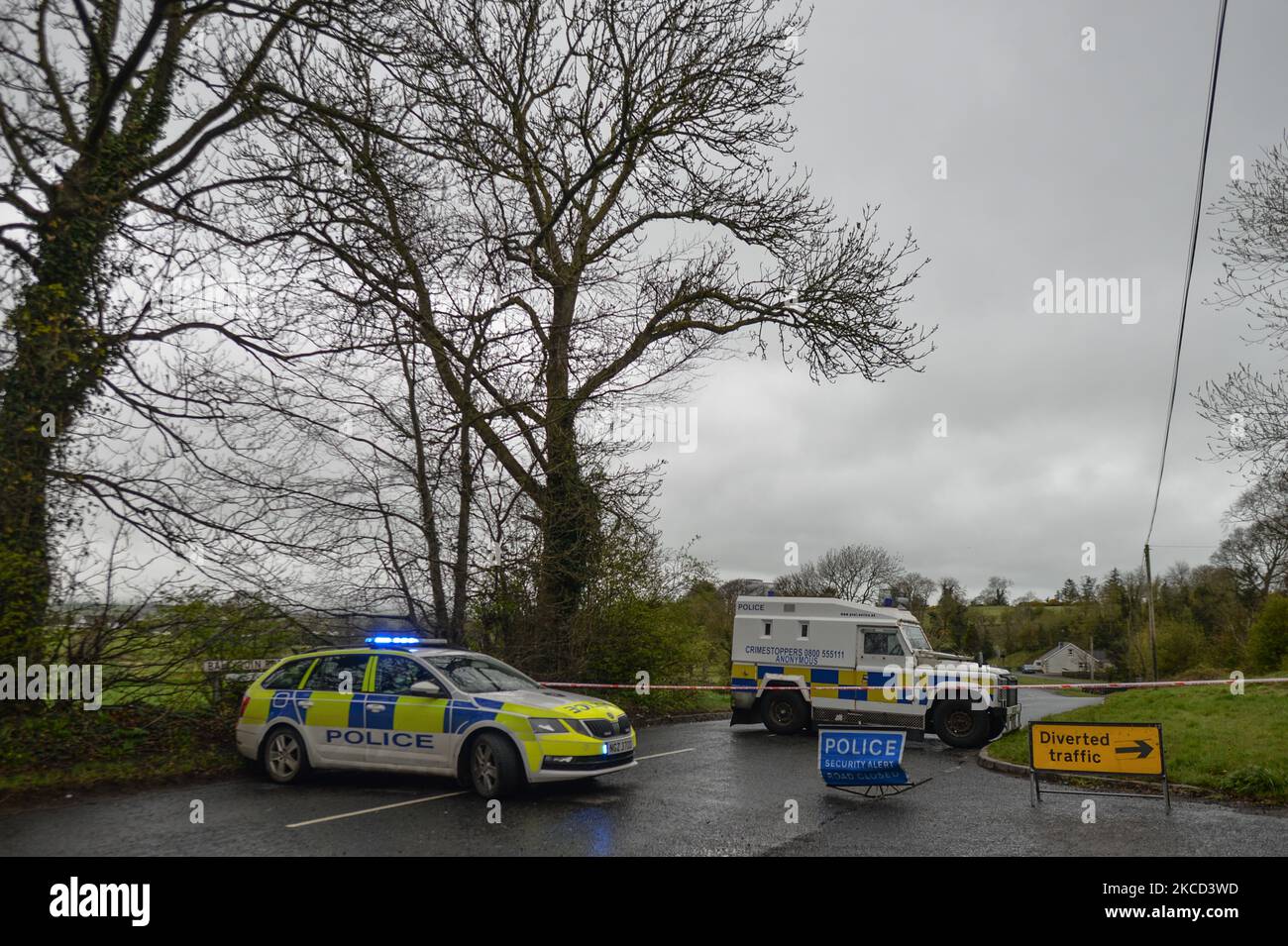 PSNI vehicles block the road during a security alert on Ballyquin Road on Monday after a viable explosive device was found near the house in a rural area near Dungiven. On Tuesday, April 20, 2021, in Dungiven, Co Londonderry. Northern Ireland. (Photo by Artur Widak/NurPhoto) Stock Photo