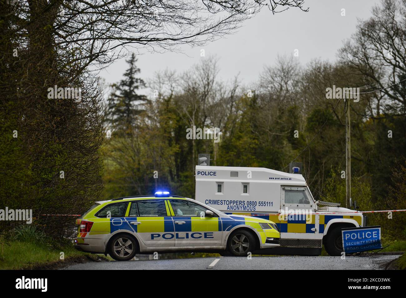 PSNI vehicles block the road during a security alert on Ballyquin Road on Monday after a viable explosive device was found near the house in a rural area near Dungiven. On Tuesday, April 20, 2021, in Dungiven, Co Londonderry. Northern Ireland. (Photo by Artur Widak/NurPhoto) Stock Photo