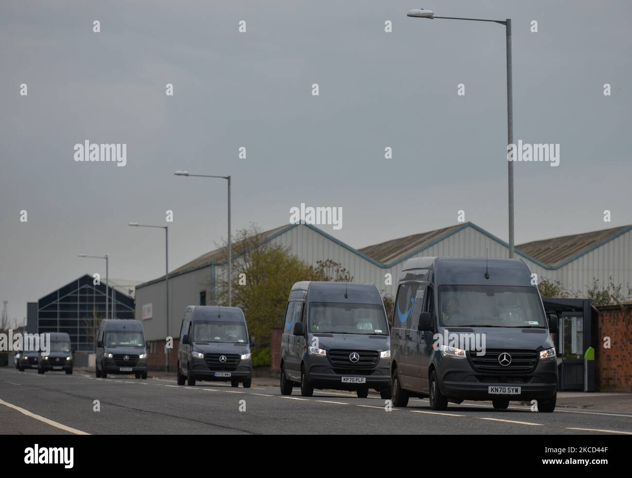 A line of Amazon Prime vans seen in the Titanic Quarter in Belfast. Packages are shipped to the delivery station from Amazon fulfillment and sorting centers and loaded onto vehicles for delivery to Amazon customers in the Belfast area. On Tuesday, April 20, 2021, in Belfast, Northern Ireland. (Photo by Artur Widak/NurPhoto) Stock Photo