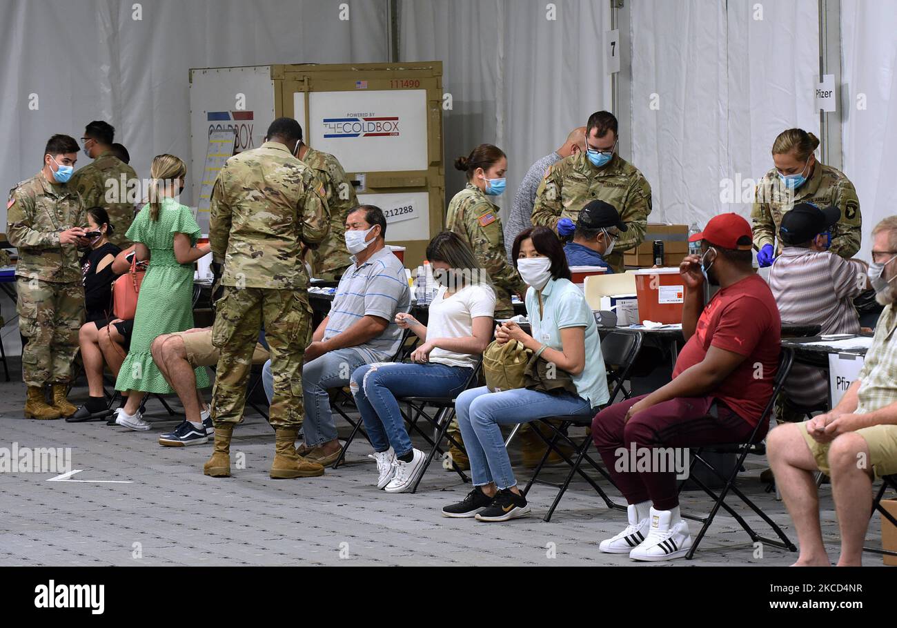 Army medics from Fort Campbell, Kentucky give COVID-19 vaccines at a FEMA supported vaccination site at Valencia State College on April 20, 2021 in Orlando, Florida. The site, which had offered the Johnson & Johnson vaccine before the vaccine pause, today began administering up to 3,000 first and second doses daily of the Pfizer vaccine. (Photo by Paul Hennessy/NurPhoto) Stock Photo