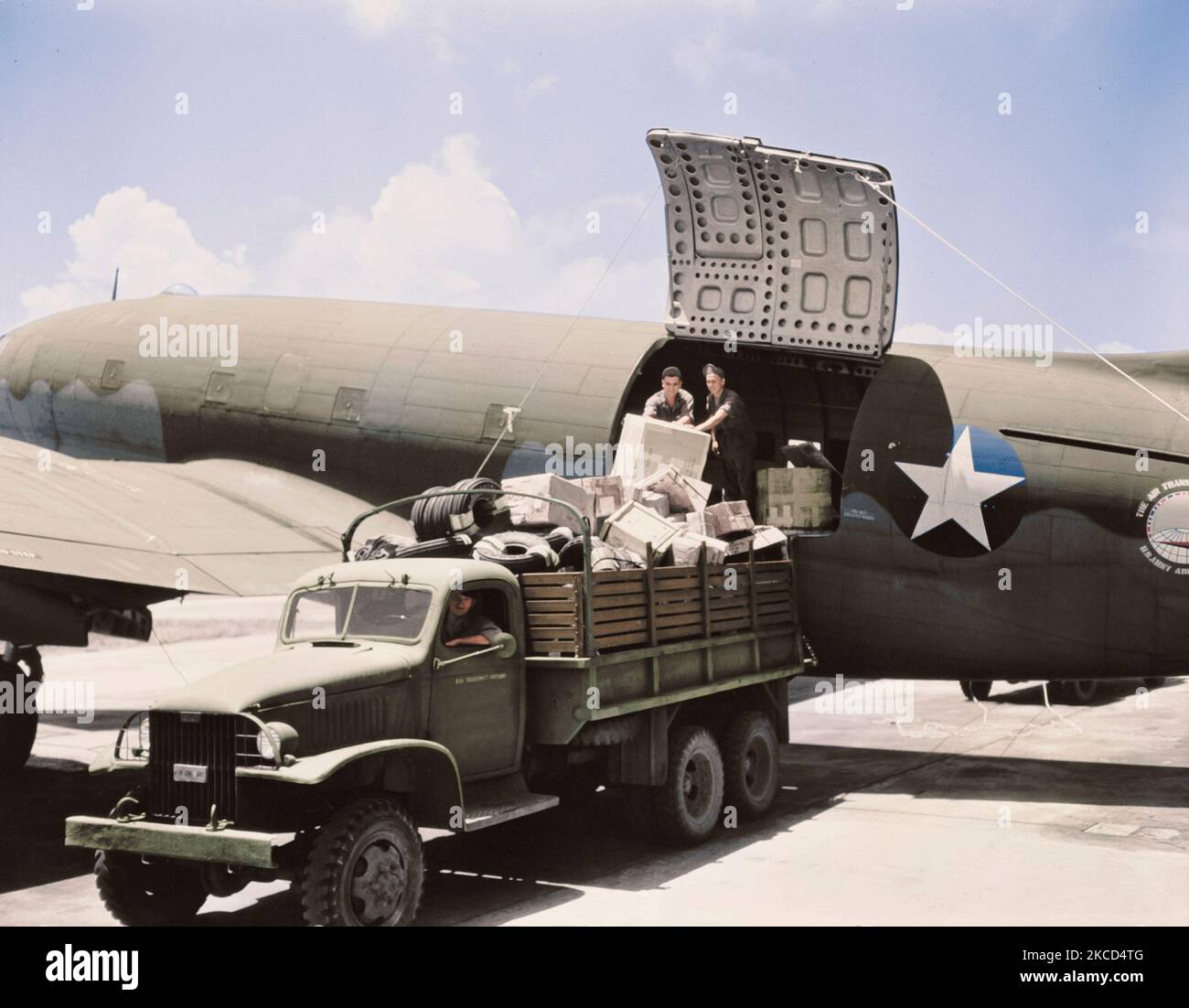 Unloading cargo from a U.S. Army Air Transport Command cargo plane, circa 1943. Stock Photo