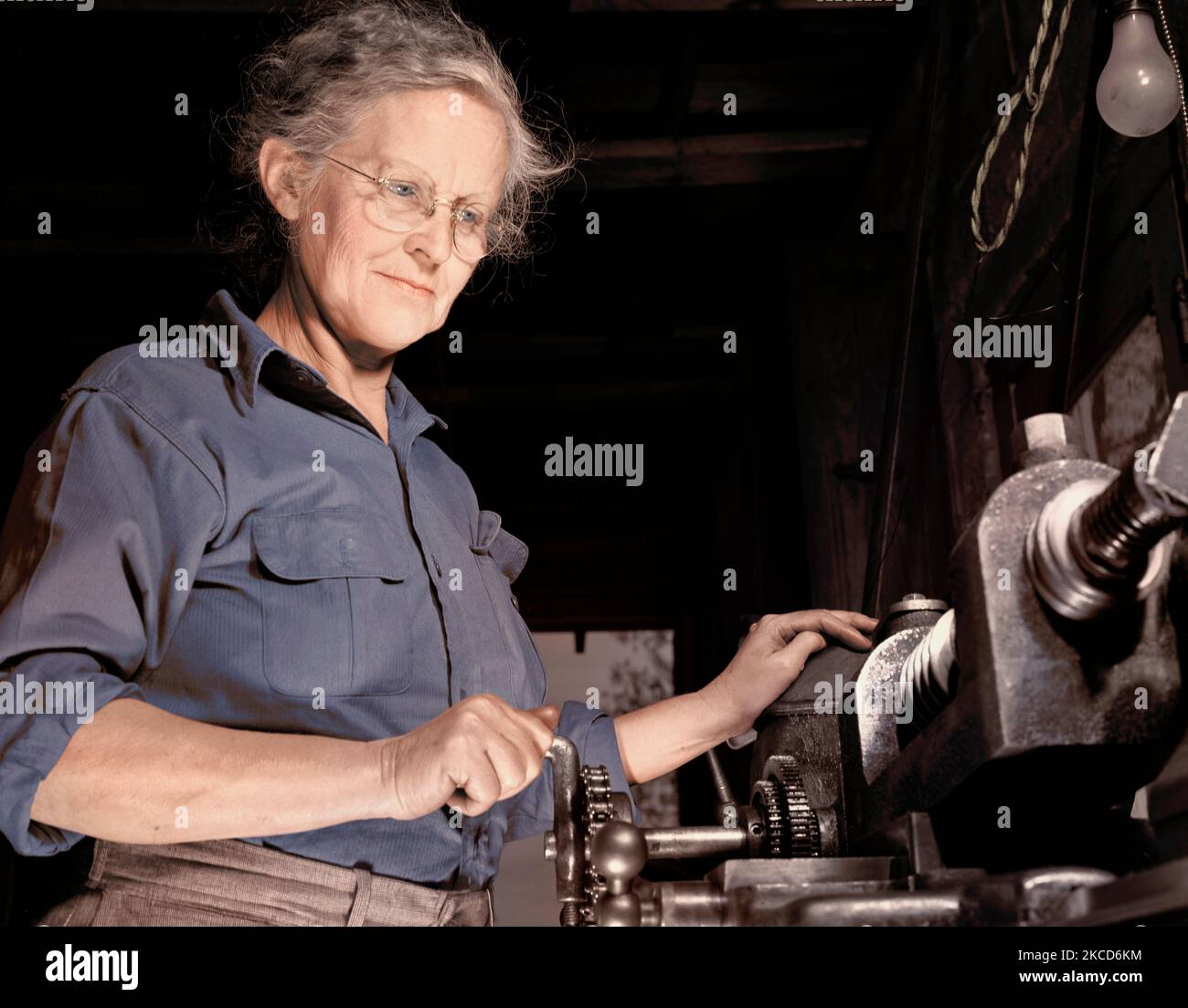 A grandmother cutting gears in her garage for U.S. Army aircraft equipment, 1942. Stock Photo