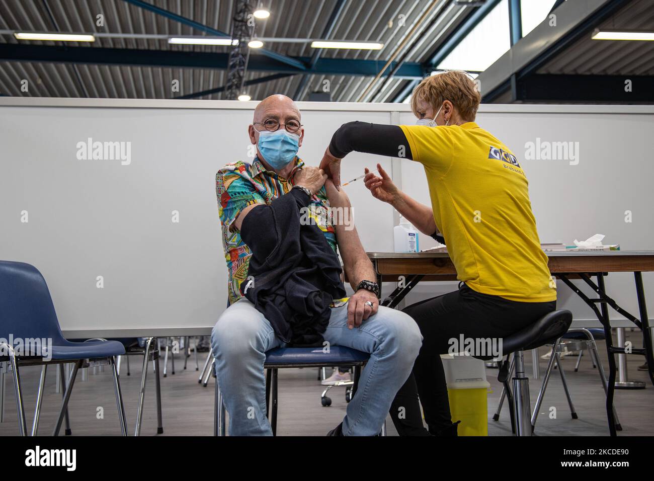 a-man-is-vaccinated-by-a-medical-healthcare-worker-holding-and
