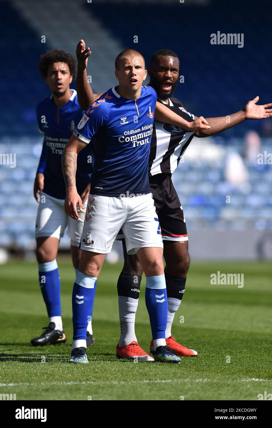 Oldham Athletic's Harry Clarke tussles with Lenell John-Lewis of Grimsby Town during the Sky Bet League 2 match between Oldham Athletic and Grimsby Town at Boundary Park, Oldham, England on 24th April 2021. (Photo by Eddie Garvey/MI News/NurPhoto) Stock Photo