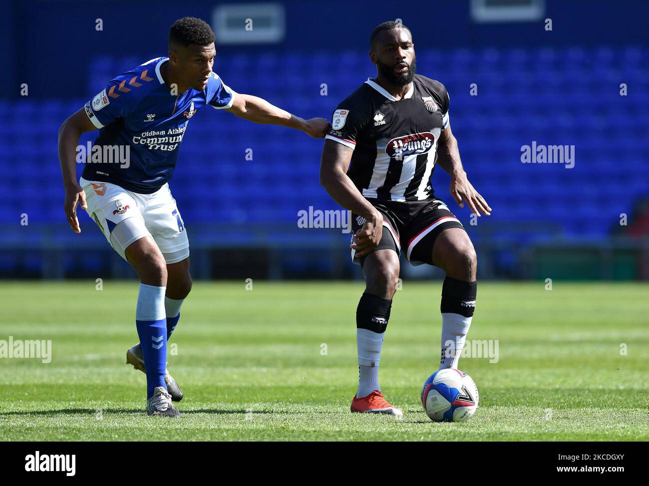 Oldham Athletic's Kyle Jameson tussles with Lenell John-Lewis of Grimsby Town during the Sky Bet League 2 match between Oldham Athletic and Grimsby Town at Boundary Park, Oldham, England on 24th April 2021. (Photo by Eddie Garvey/MI News/NurPhoto) Stock Photo
