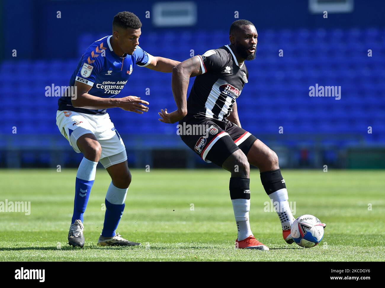 Oldham Athletic's Kyle Jameson tussles with Lenell John-Lewis of Grimsby Town during the Sky Bet League 2 match between Oldham Athletic and Grimsby Town at Boundary Park, Oldham, England on 24th April 2021. (Photo by Eddie Garvey/MI News/NurPhoto) Stock Photo