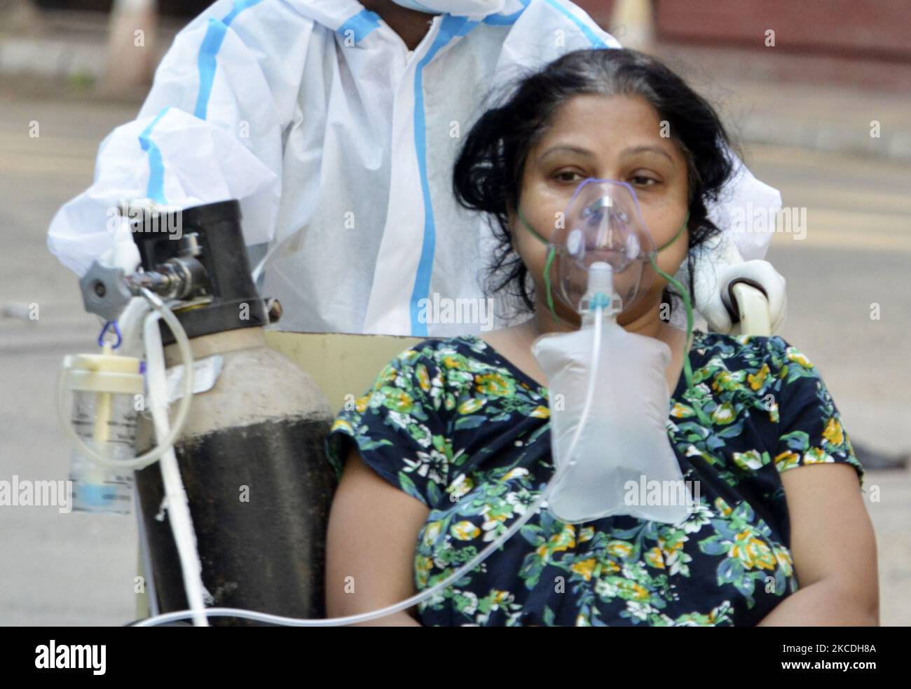 A Covid19 patient on a wheel chair goes for a medical test inside a government hospital in