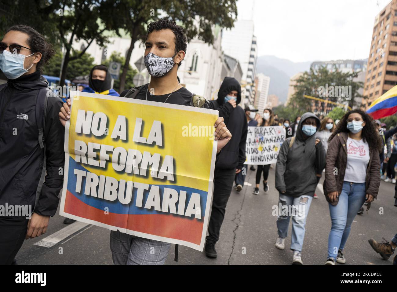 A protester holds a sign that says -No To the Tax Reform- in the protest against the tax reform proposed by the national government a few weeks ago in Bogota, Colombia, on April 28, 2021.(Photo by David Rodriguez/NurPhoto) Stock Photo