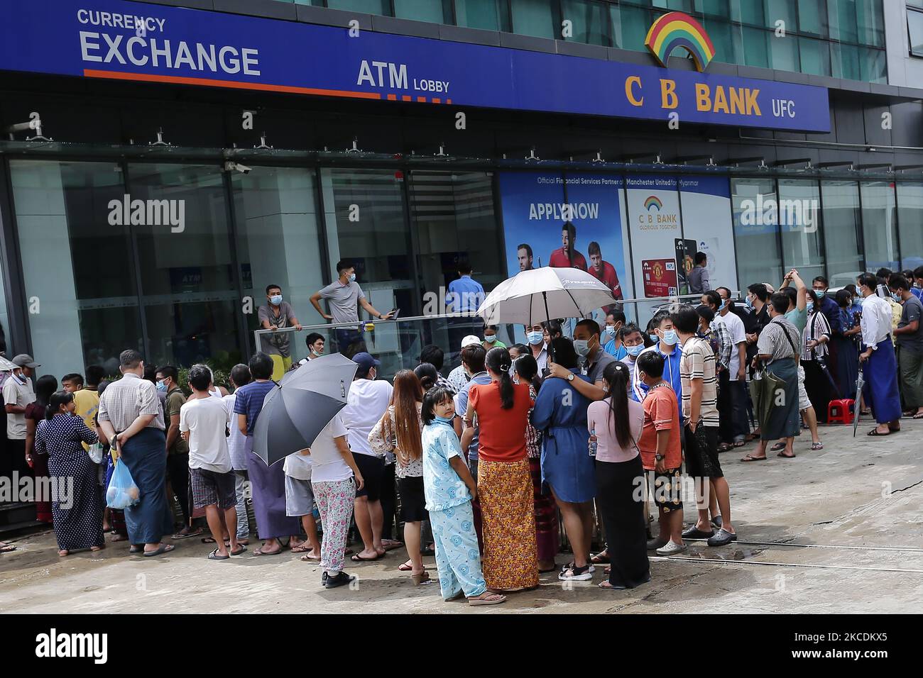 People queue for a long time to withdraw money from ATM machines of CB Bank  at the downtown area in Yangon on April 30, 2021 following the Myanmar  military coup in early