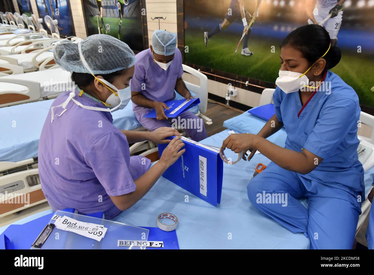 Health workers arrange files for newly installed medical beds in