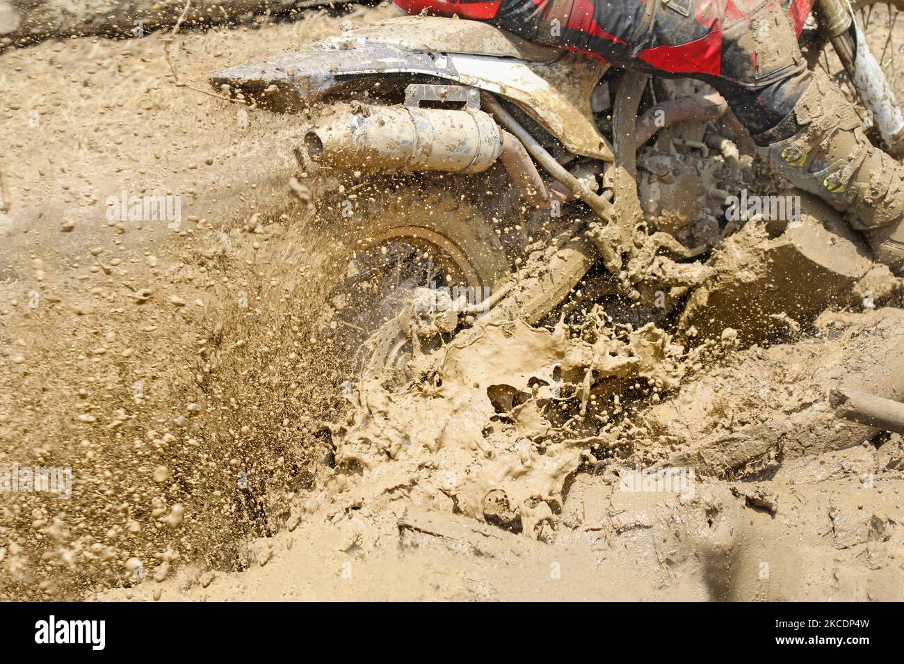 Motocross accelerating speed in mud Stock Photo