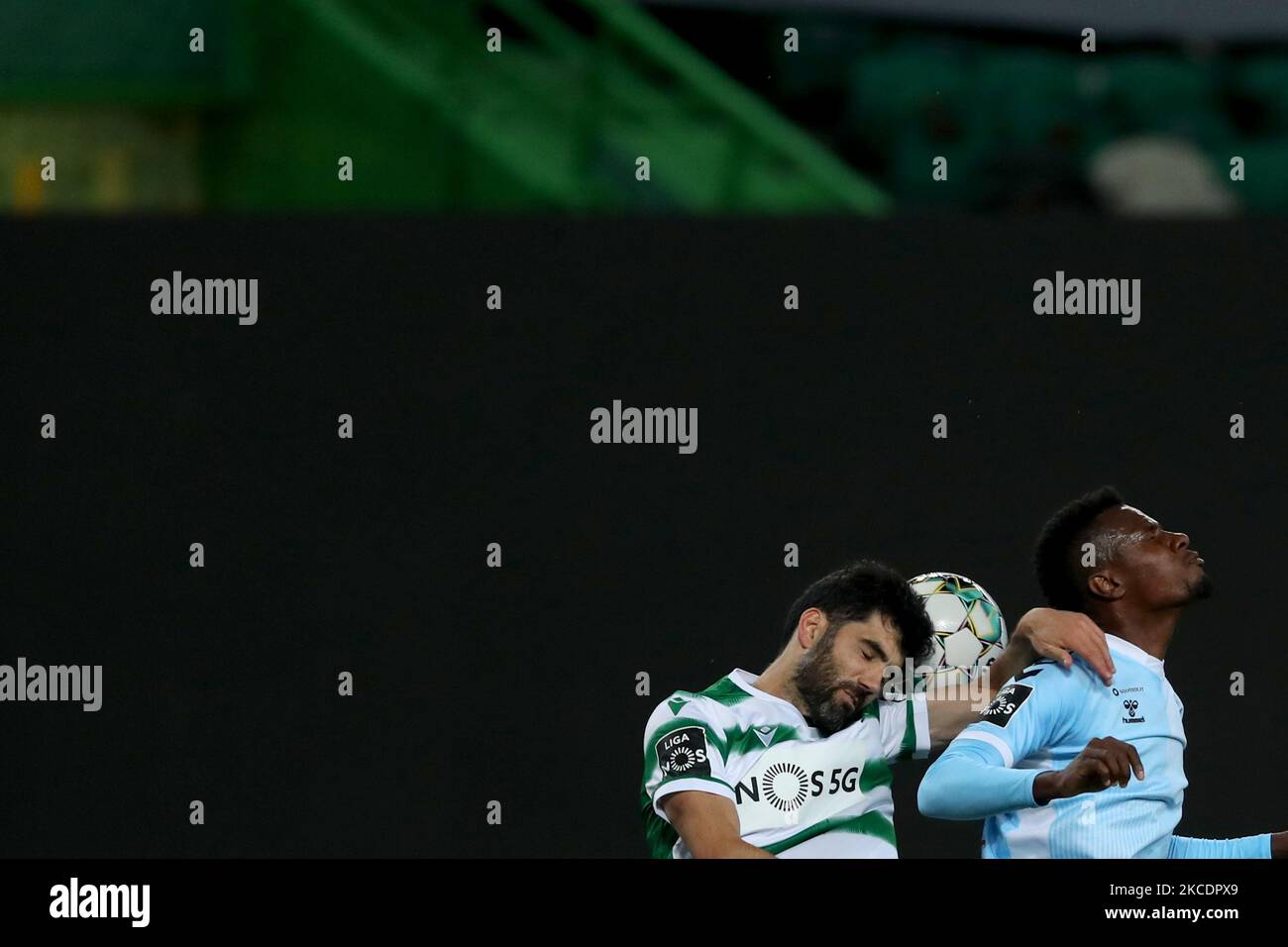 Luis Neto of Sporting CP (L) vies with Pedrao of CD Nacional during the Portuguese League football match between Sporting CP and CD Nacional at Jose Alvalade stadium in Lisbon, Portugal on May 1, 2021. (Photo by Pedro FiÃºza/NurPhoto) Stock Photo