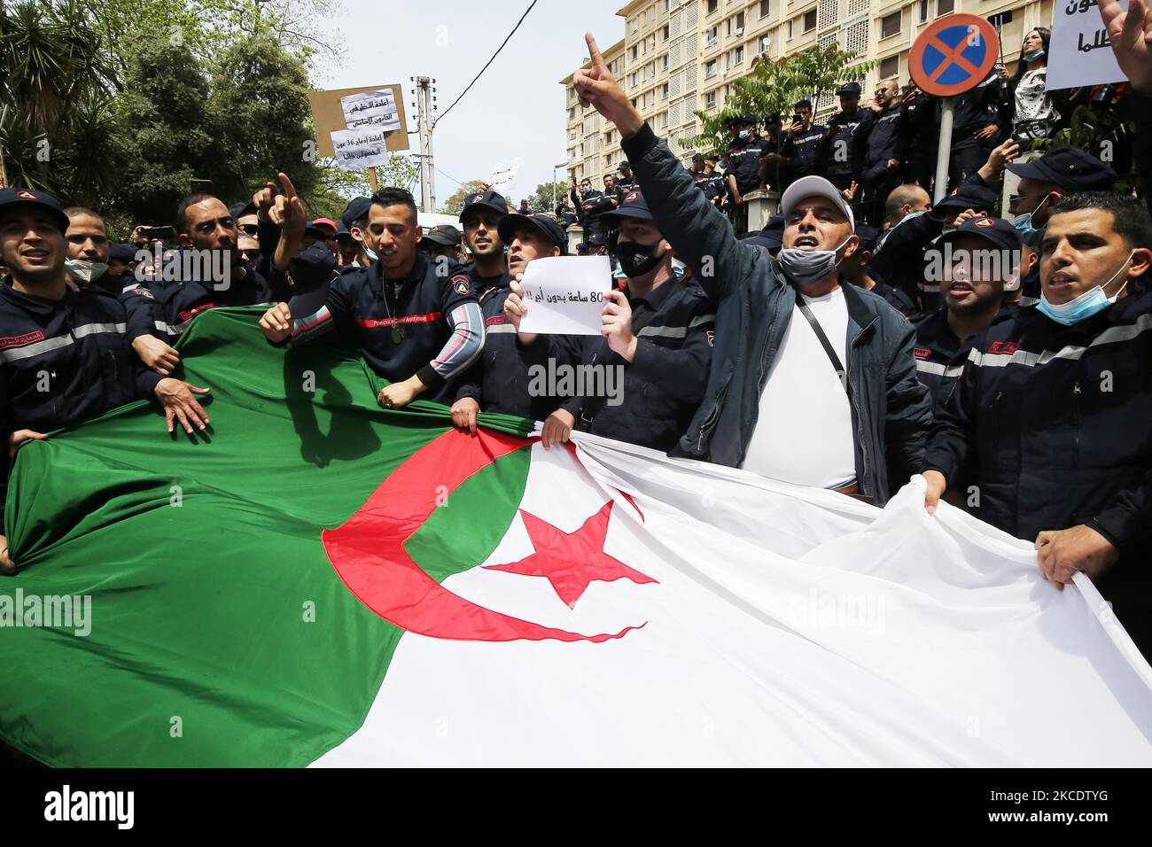 Members of the Algerian Civil Protection gesture as they march towards the service's headquarters in the capital Algiers, on May 2, 2021, to protest the detainment by the police of their representative during a previous demonstration demanding better work conditions (Photo by Billal Bensalem/NurPhoto) Stock Photo