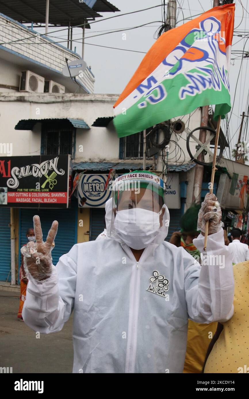 A Supporte of the All India Trinamool Congress (AITC) wearing a Personal protective equipment (PPE) suit and hold TMC Party flag at the celebrate the party's lead during the ongoing counting process of the West Bengal legislative assembly election, in Kolkata on May 2, 2021. (Photo by Debajyoti Chakraborty/NurPhoto) Stock Photo