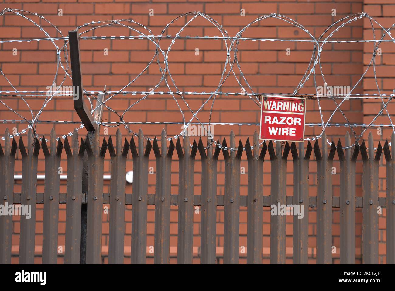 A high wall with barbed wire fence that separates the two communities in East Belfast. On Monday, April 19, 2021, in Belfast, Northern Ireland (Photo by Artur Widak/NurPhoto) Stock Photo