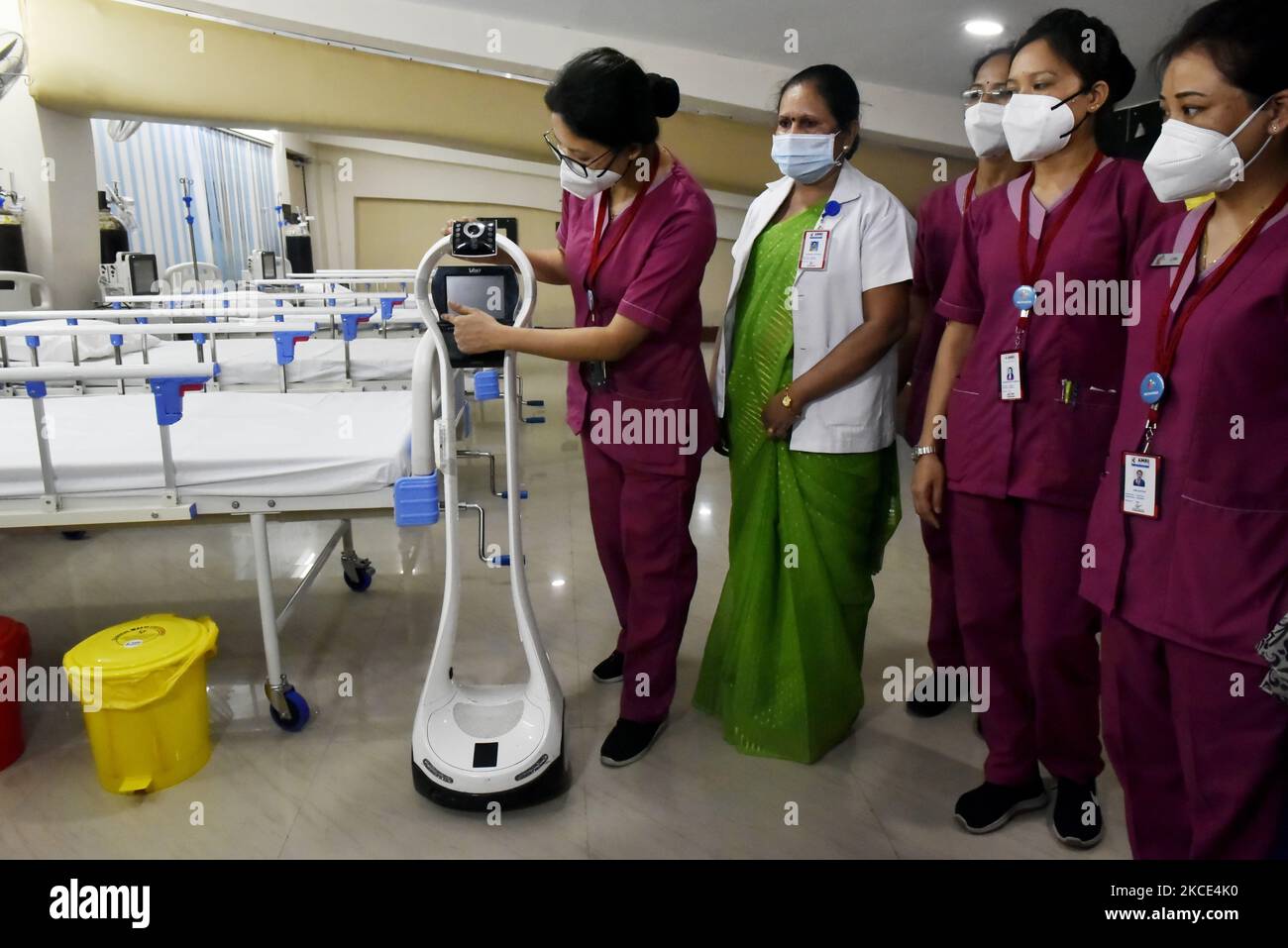 Health workers give demo of a machine where a covid patient can talk to a doctor through this machine in a temporary converted covid care unit in Salt Lake stadium in Kolkata, India on 7 May, 2021. India records fresh 4 lakh 14 thousand covid-19 cases according to an Indian media report. (Photo by Indranil Aditya/NurPhoto) Stock Photo