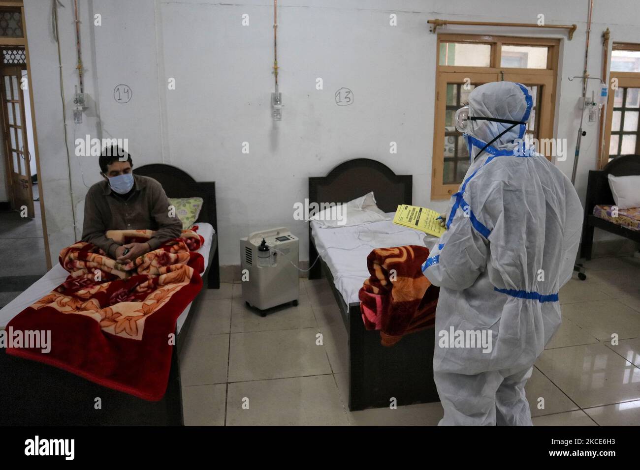 A Health worker examins a Covid-19 patient at a temporary Covid-19 hospital in Srinagar, Indian Administered Kashmir on 08 May 2021. A Local NGO Athrout has converted Hajj house into a 100-bedded Covid centre as the space in hospitals (Photo by Muzamil Mattoo/NurPhoto) Stock Photo