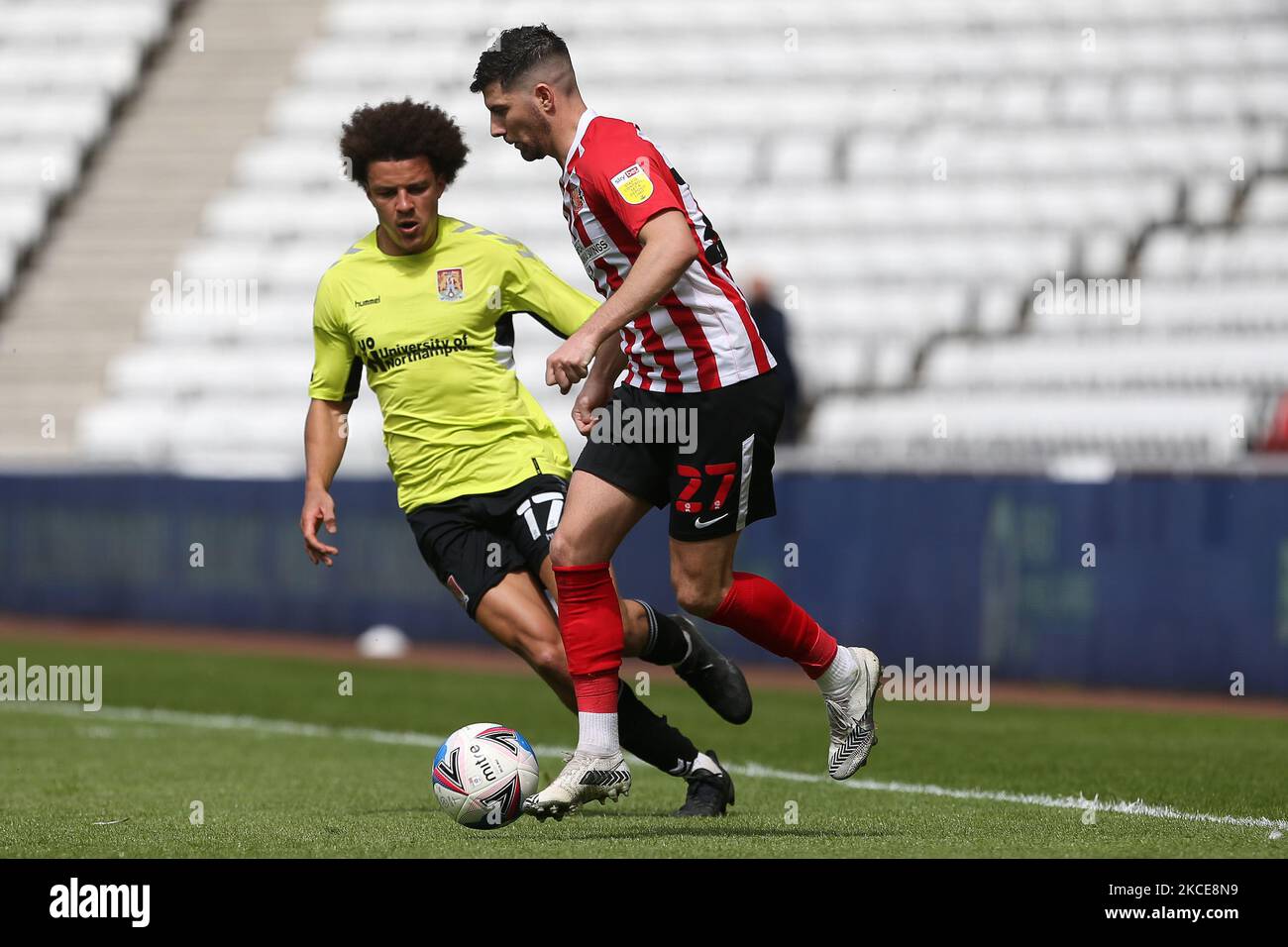 Jordan Jones of Sunderland in action with Shaun McWilliams of Northampton Town during the Sky Bet League 1 match between Sunderland and Northampton Town at the Stadium Of Light, Sunderland, UK on 9th May 2021. (Photo by Mark Fletcher/MI News/NurPhoto) Stock Photo