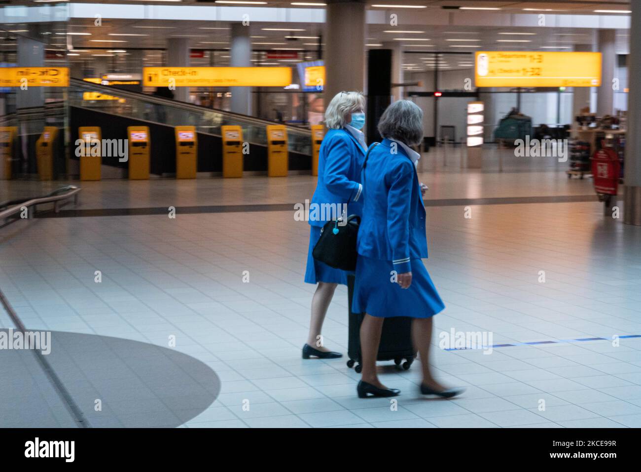 KLM flight crew with facemask. Inside the terminal of Amsterdam
