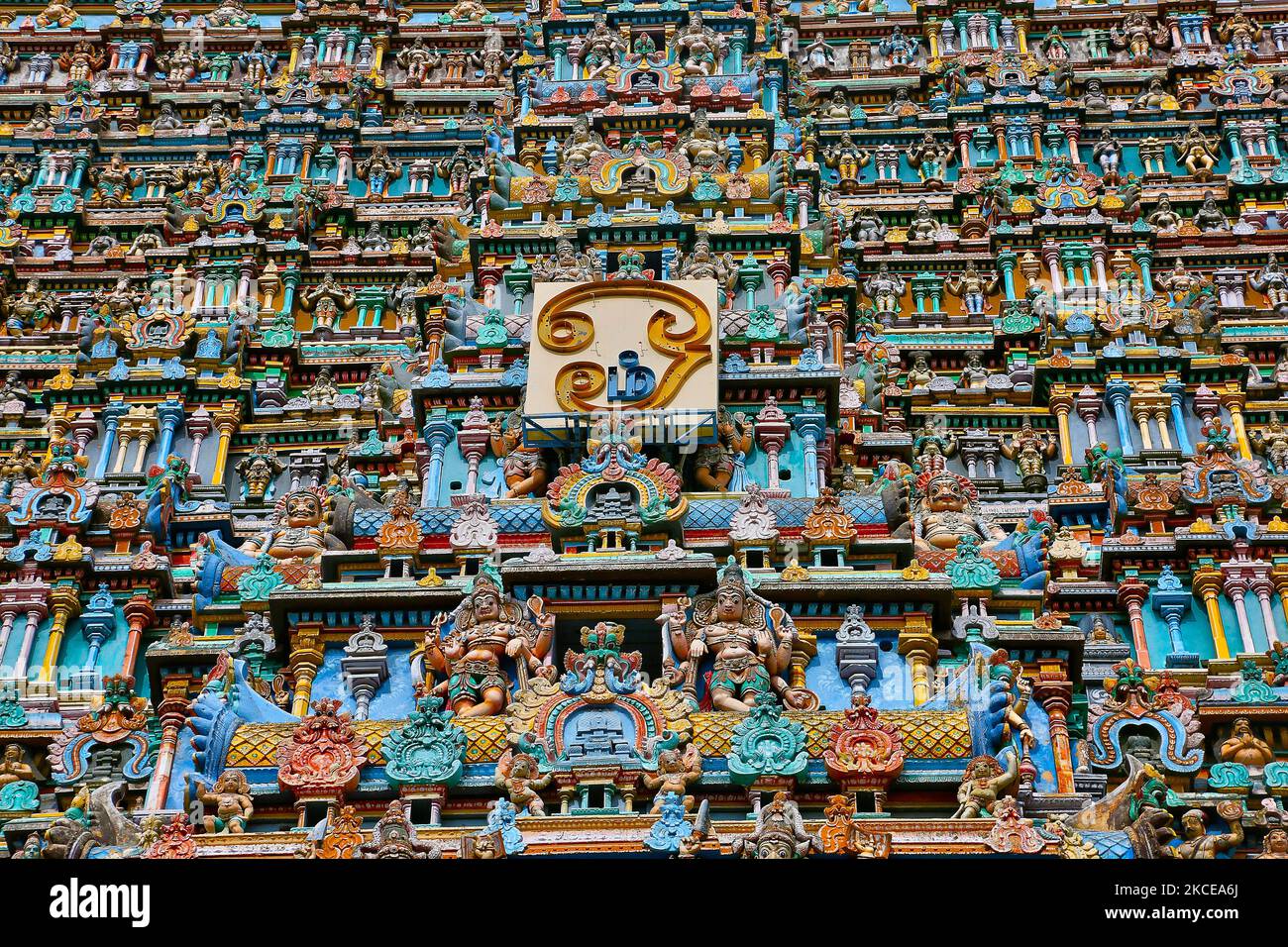 Colourful figures of Hindu deities adorn the gopura tower of the Madurai Meenakshi Amman Temple (Arulmigu Meenakshi Sundareshwarar Temple) located in Madurai, Tamil Nadu, India. The temple is at the center of the ancient temple city of Madurai mentioned in the Tamil Sangam literature, with the goddess temple mentioned in 6th-century-CE texts. Madurai Meenakshi Sundareswarar temple was built by King Kulasekara Pandya (1190-1216 CE). He built the main Portions of the three-storied gopura (tower) at the entrance of Sundareswarar Shrine and the central portion of the Goddess Meenakshi Shrine are s Stock Photo
