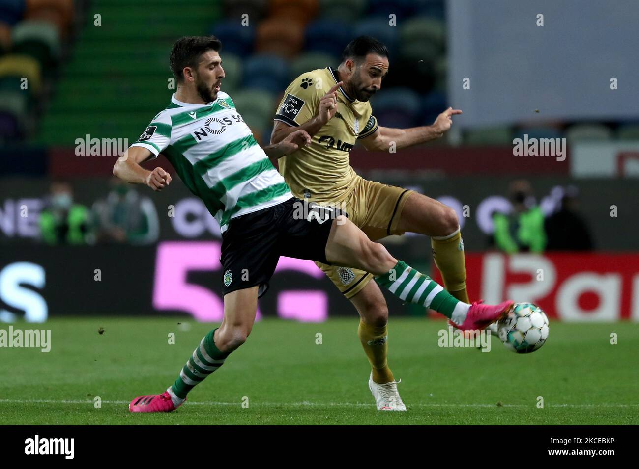 Paulinho of Sporting CP (L) vies with Adil Rami of Boavista FC during the Portuguese League football match between Sporting CP and Boavista FC at Jose Alvalade stadium in Lisbon, Portugal on May 11, 2021. (Photo by Pedro FiÃºza/NurPhoto) Stock Photo