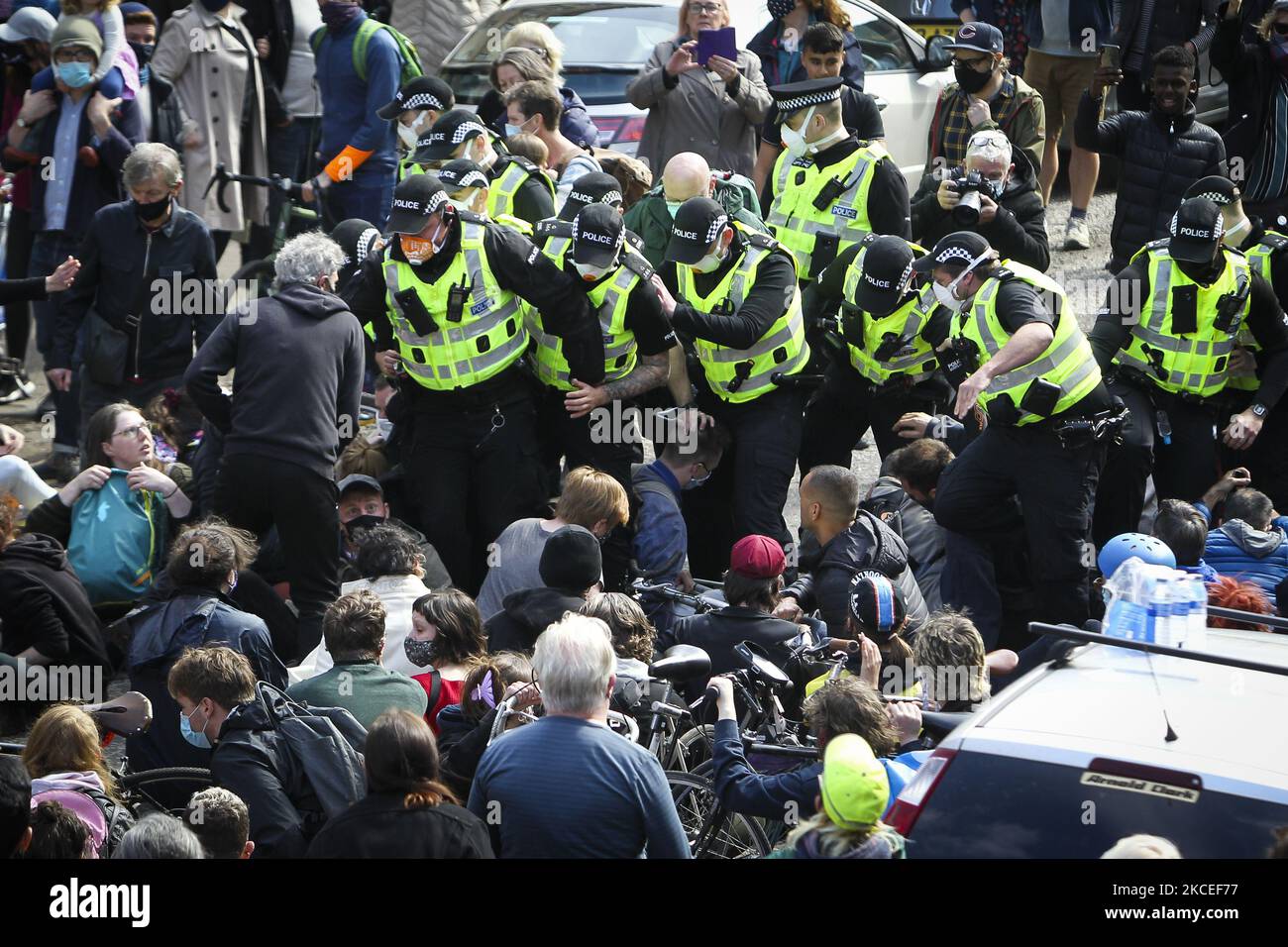 Police officers clash with protestors who are blocking a UK home office