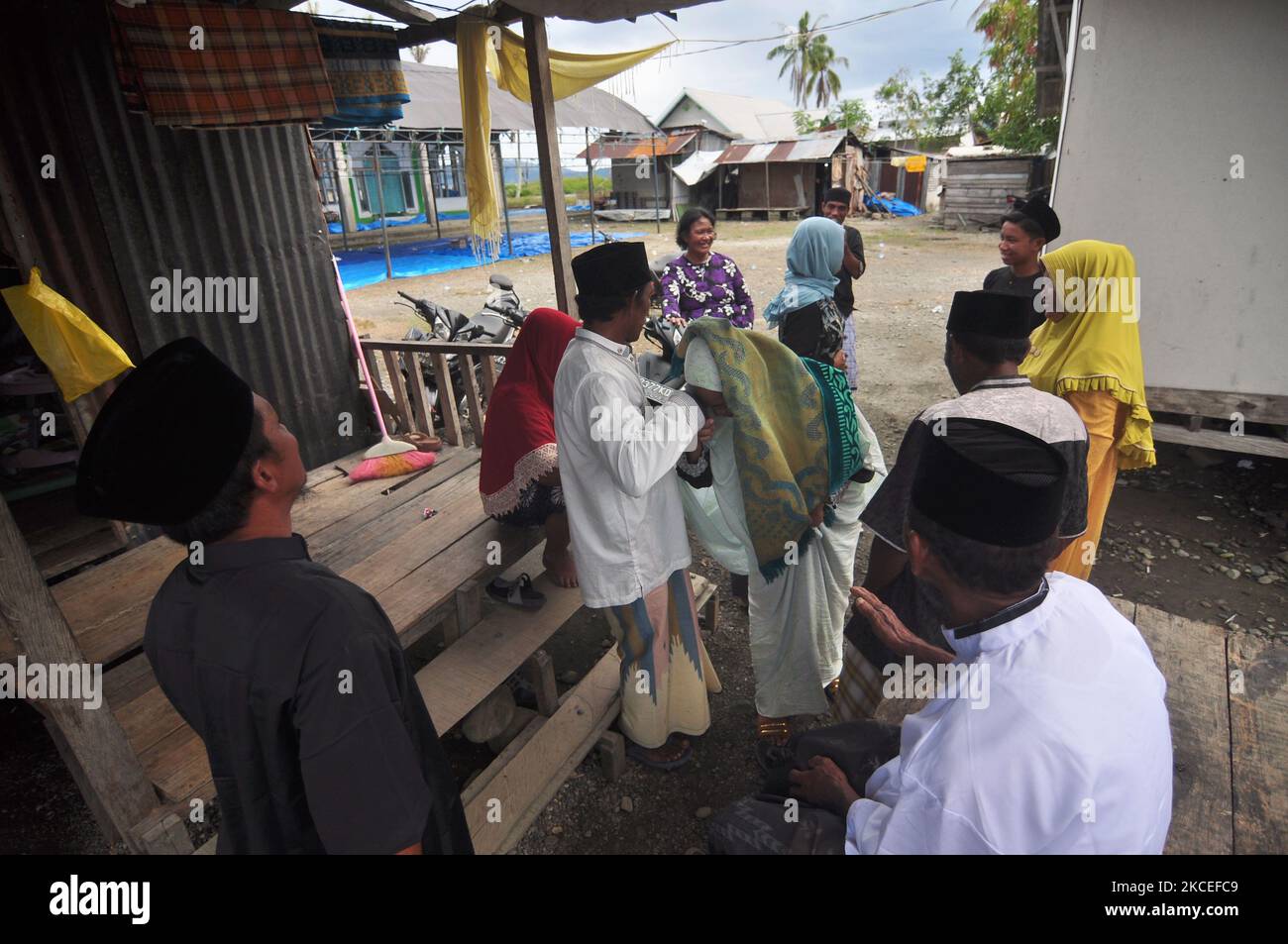 The mosque congregation shakes hand in hand, after performing the Eid prayer at the mosque, Tompe Village, Sirenja District, Donggala Regency, Central Sulawesi Province, Thursday, May 13, 2021. Greetings, is a unique tradition that almost all regions in Donggala have, it intends to forgive one another. (Photo by Faldi Muhammad/NurPhoto) Stock Photo