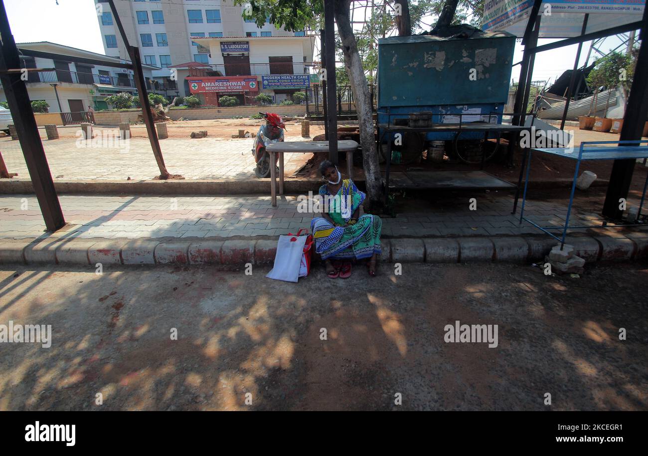 A relative of a patient naps on wayside just outskirts of the AIIMS hospital in between the lockdown period in the eastern Indian state Odisha's capital city Bhubaneswar. (Photo by STR/NurPhoto) Stock Photo
