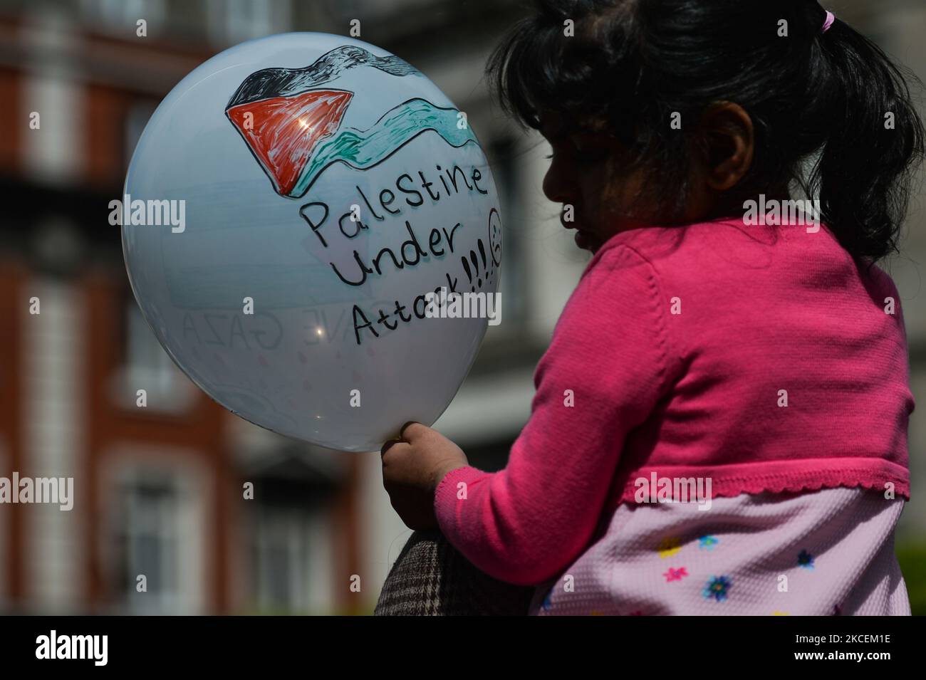 A young Pro-Palestinian protester holds a balloon with words 'Palestine Under Attack!!!'' on O'Connell Street in Dublin city center during 'Rally for Palestine'. On Saturday, 15 May 2021, in Dublin, Ireland. (Photo by Artur Widak/NurPhoto) Stock Photo