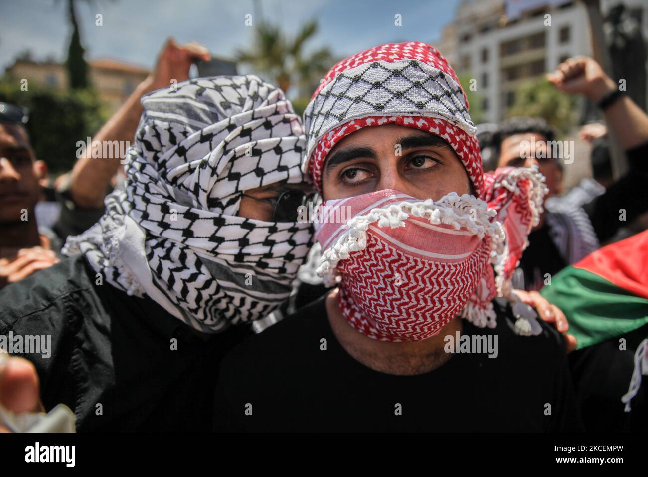 Protesters wearing the Palestinian keffiyeh attend a demonstration held by thousands of Tunisian an Palestinian demonstrators on avenue Habib Bourguiba in the capital Tunis, Tunisia, on May 15, 2021, in support with the Palestinian people and to protest against the Israel's air strikes on Gaza strip and against the Israeli violations in the occupied territories in Palestine, especially in the Palestinian neighborhood in East Jerusalem, Sheikh Jarrah. (Photo by Chedly Ben Ibrahim/NurPhoto) Stock Photo