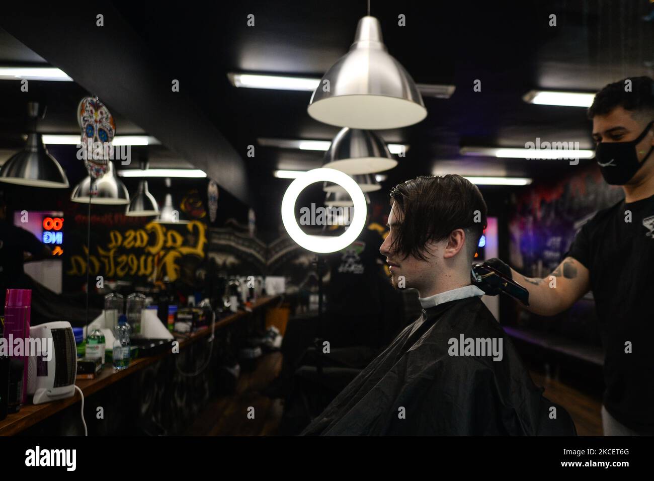 A hairdresser serves a customer at a barbershop in Dublin city centre.  Ireland takes another step towards normality with all non-essential retail  being allowed to resume from today. On Monday, 17 May