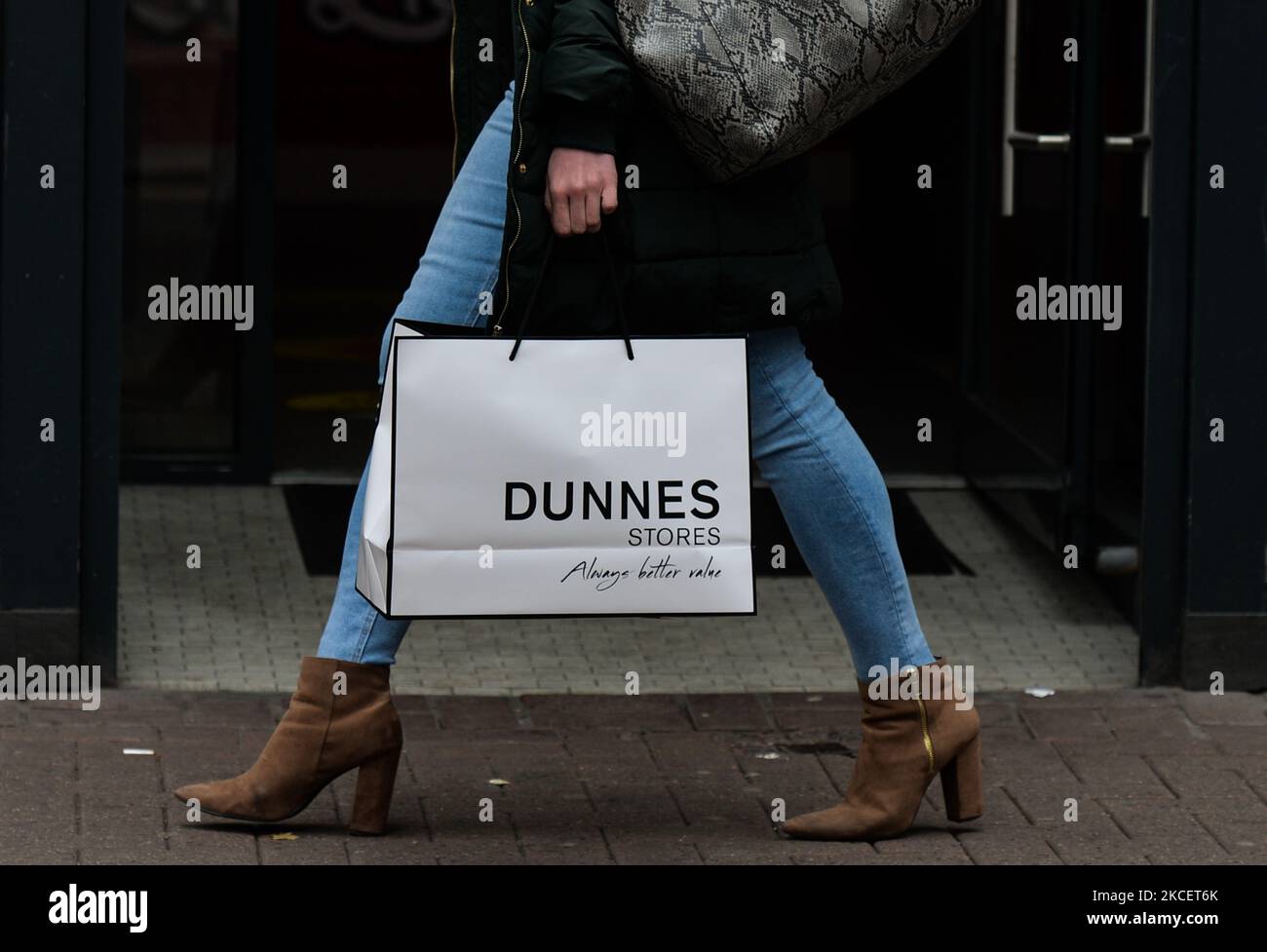 A woman walks with Dunnes Stores shopping bag on Grafton Street in