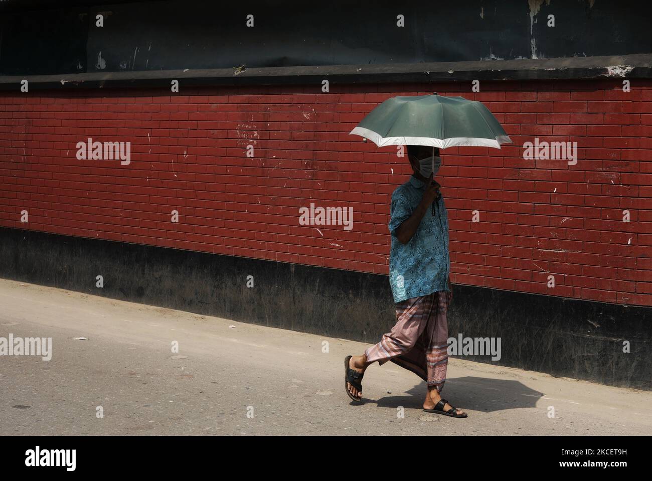 Pedestrian holds umbrella under hi-res stock photography and images - Alamy