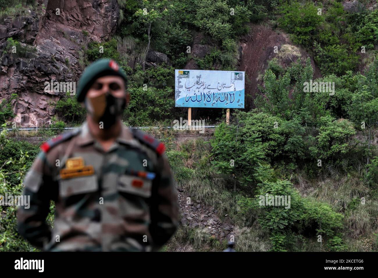 An Indian army officer stands near the Aman Setu bridge as Pakistan flag is seen on the other side on LoC in URI sector of District Baramulla, Jammu and Kashmir, India on 18 May 2021. Indiaâ€“Pakistan relations refer to the bilateral relations between India and Pakistan. The relations between the two countries have been complex and largely hostile due to a number of historical and political events. Relations between the two states have been defined by the violent partition of British India in 1947 which started the Kashmir conflict, and the numerous military conflicts fought between the two na Stock Photo