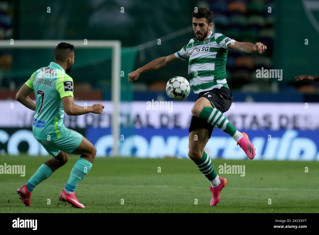 Paulinho of Sporting CP (R ) vies with Rafik Guitane of CS Maritimo during the Portuguese League football match between Sporting CP and CS Maritimo at Jose Alvalade stadium in Lisbon, Portugal on May 19, 2021. (Photo by Pedro FiÃºza/NurPhoto) Stock Photo